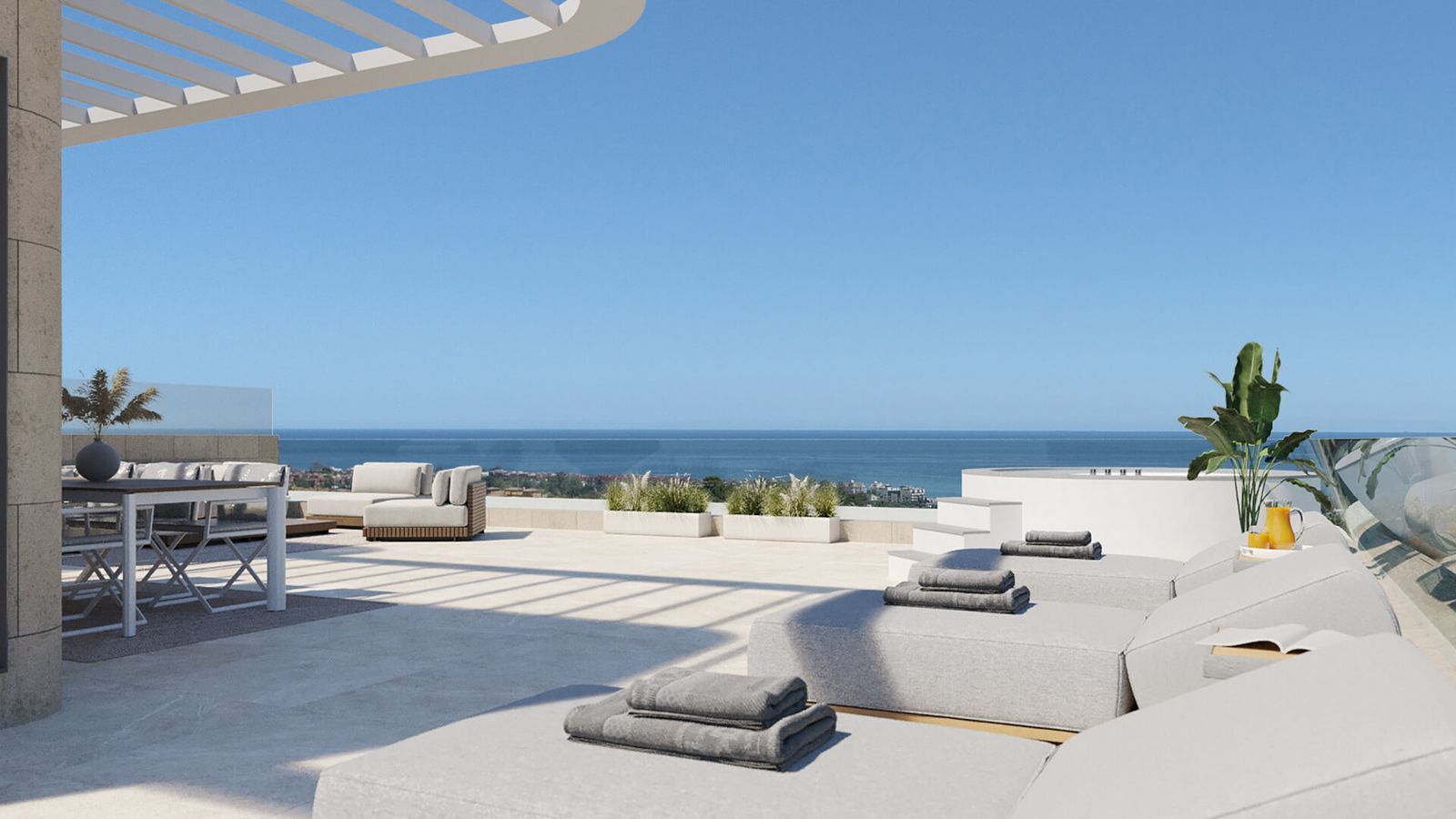 Terraza de lujo con vistas al mar, tumbonas, mesa de comedor y jacuzzi.